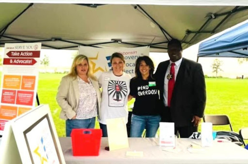 RAP-WI members Amy Anderson, Jessica Geschke, Jill Whitmarsh, and Dane County Sheriff Kalvin Barrett showed support for Wisconsin recovery in September at the Overdose Awareness Day Remembrance event at Olbrich Park.